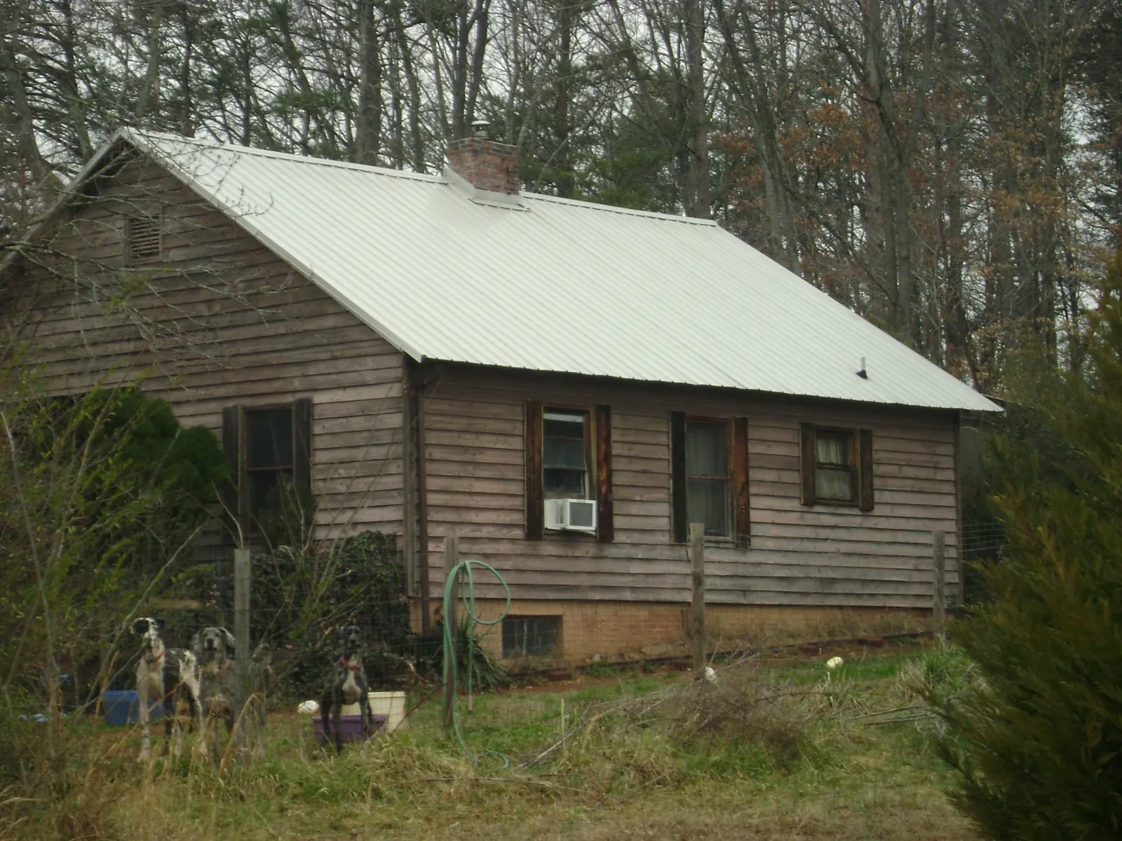 White metal roof on an old wood sided farmhouse, from a Metal Roof Installation job in Rensselaer